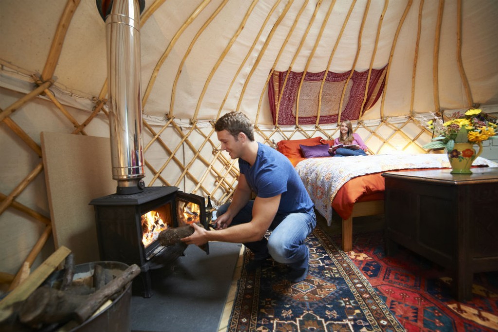 Couple Enjoying Luxury Camping Holiday In Yurt