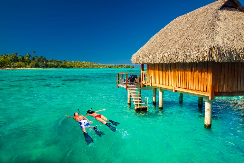 Couple snorkeling in tropical lagoon