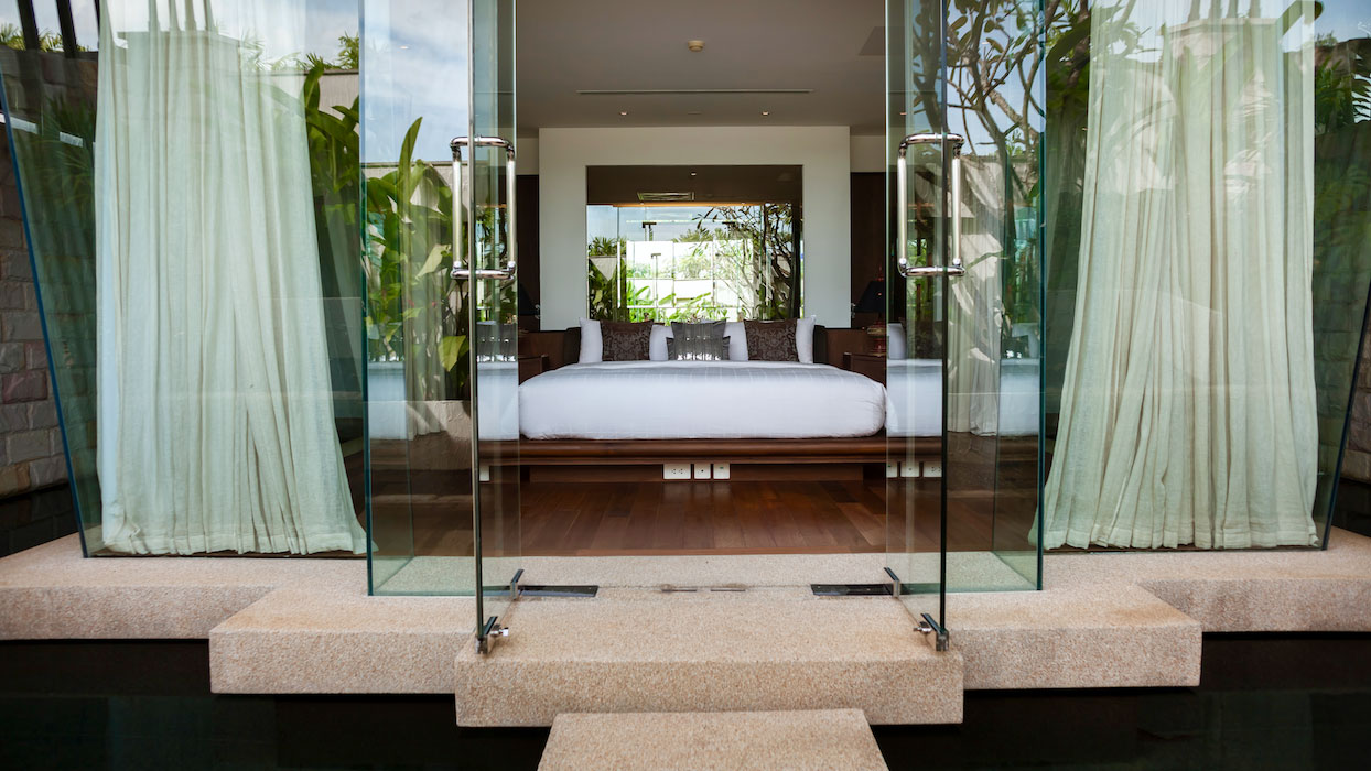 bedroom with glass walls - villa kalyana phuket
